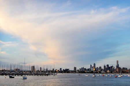 A view of the Melbourne city beach pier, with harmonious sunlight and many boats for fishingの写真素材
