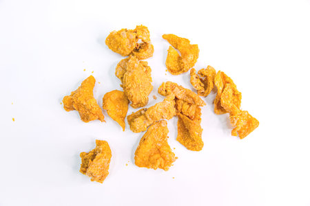 Zoomed-in View of Asian Fried Crispy Chicken Skin on a White Backgroundの写真素材