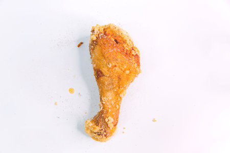 Asian Classic Fried Chicken Leg, Marinated with Savory Taiwanese Seasoning on an Isolated White Backgroundの写真素材