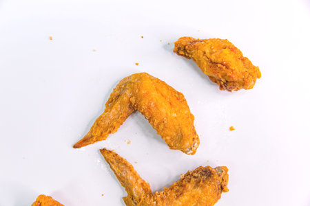 Asian Classic Fried Chicken Wings with Savory Taiwanese Seasoning on a White Backgroundの写真素材
