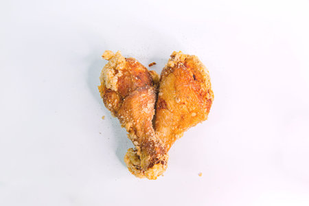 Asian Classic Fried Chicken Leg, Marinated with Savory Taiwanese Seasoning on an Isolated White Backgroundの写真素材