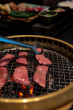 Gourmet Ox Tongue with Assorted Sides and Dipping Sauces for Authentic Japanese or Korean BBQ, Offering Traditional Asian Flavorsの写真素材