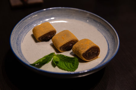 Donkey Roll, Ludagun: Beijing's Fried Chop Rice Cake with Soybean and Red Bean on Textured Plateの写真素材