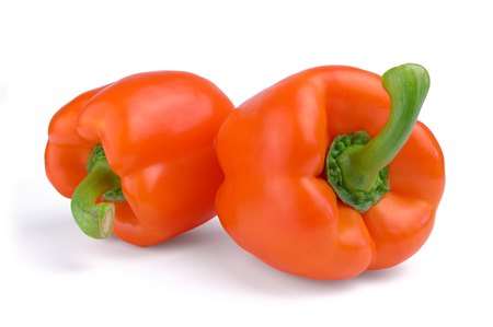 Two red sweet peppers isolated on white background.の写真素材