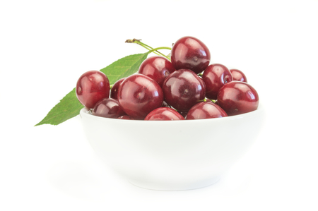 Bright Cherry in the bowl with leaf.の写真素材