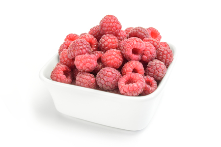 Big Pile of Fresh Raspberries in the White Bowl Isolated on the White Backgroundの写真素材