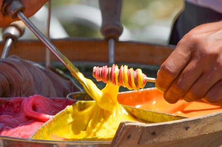 salesman prepare traditional turkish candy stick on street.の写真素材