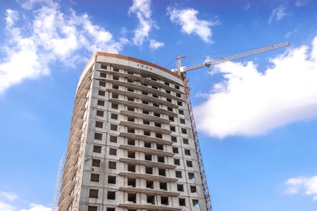Construction site with cranes on sky background