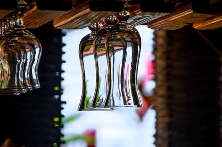 Empty glasses for alcohol beverage above a bar rack backgroundの写真素材