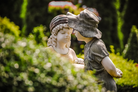 The first kiss. Statue of boy and girl in the park.の写真素材