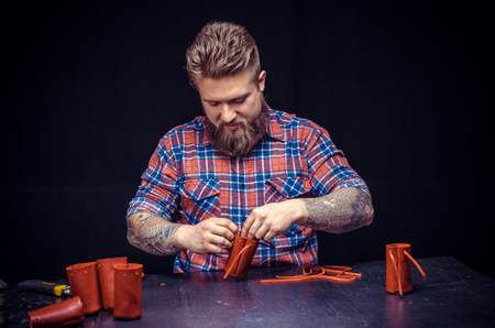 Leather workman creates quality product of leather in his shop