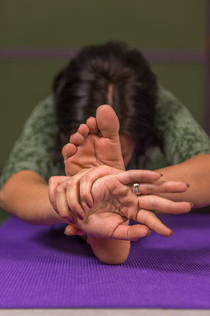 Yoga master teaches yoga lesson in a studioの写真素材