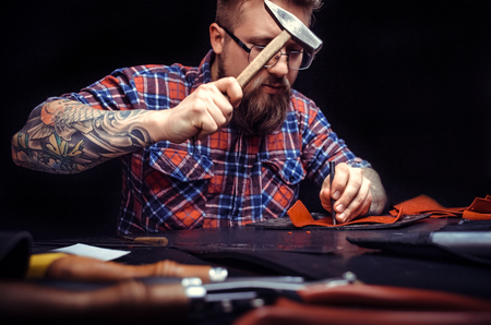 Hammering holes through leather productの写真素材