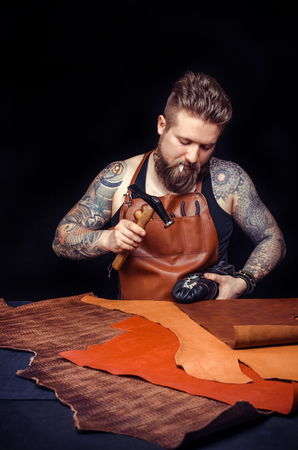 Portrait of shoemaker hammering on a shoeの写真素材