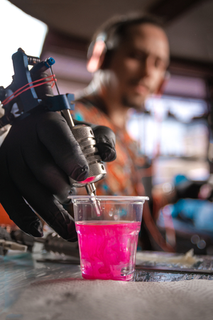 Professional tattooer works in tattoo studioの写真素材