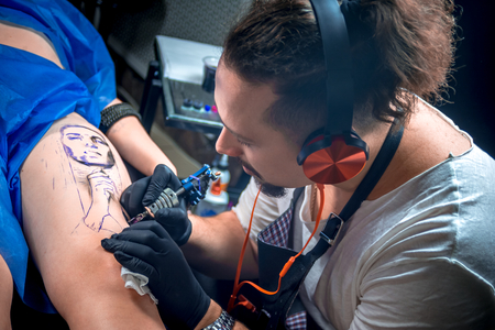 Tattoo artist making tattoo art in a workshop studioの写真素材