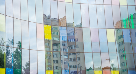 Window reflections at the glass facade of an office buildingの写真素材