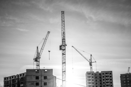Powerful crane and new housesの写真素材