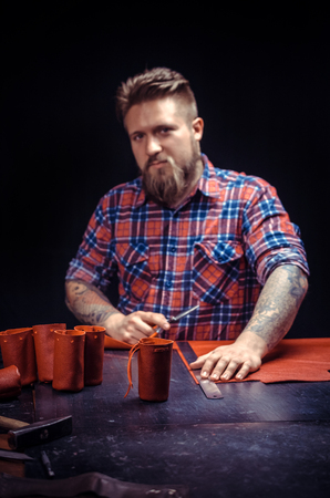 Craftsman creating a new leather product at his workshop