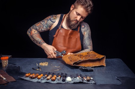 Currier of leather making quality products in the tanner shopの写真素材