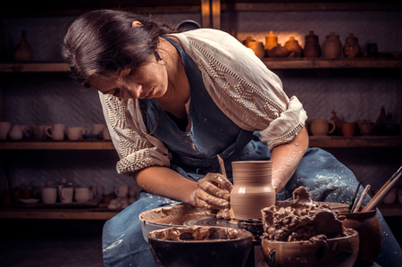 Beautiful handicraftsman master making ceramic pot on the pottery wheel . Handcraft.の写真素材