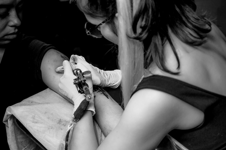 Tattoo artist posing in tattoo parlourの写真素材