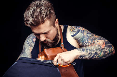 Worker of leather at work on his new leather product