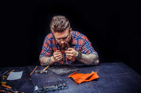 Leather cutter working as artisan at his leather shopの写真素材