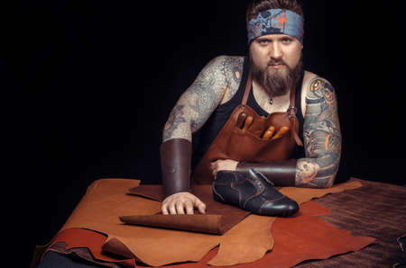 Professional Tanner working with leatherwork at the workplace