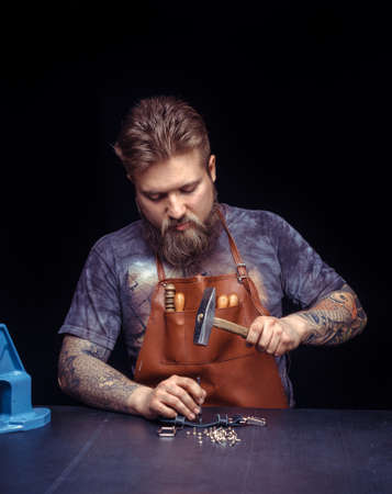 Leather Artisan being keen on his buisness at leather shop