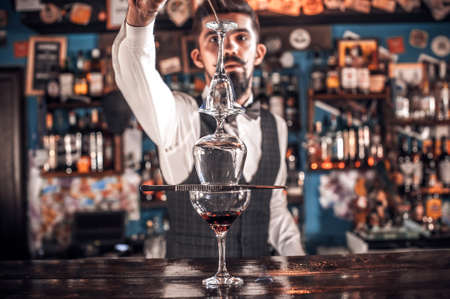 Portrait of bartending demonstrates the process of making a cocktailの写真素材