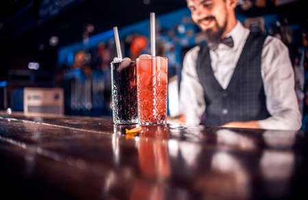 Focused barman surprises with its skill bar visitors at barの写真素材