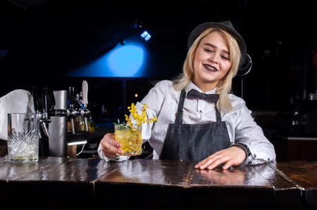 Girl barman makes a cocktail at the brasserieの写真素材