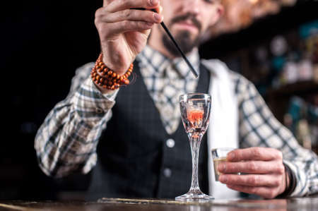 Experienced Female bartender makes a cocktail on the barの写真素材