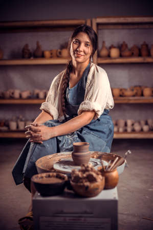 Pottery master demonstrates a finished clay bowl in the workshop  . Making pottery.の写真素材