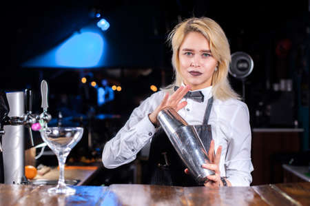 Girl barman creates a cocktail at the beerhallの写真素材