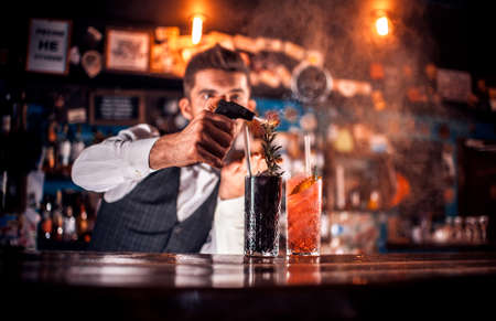 Young tapster makes a cocktail in cocktail barsの写真素材