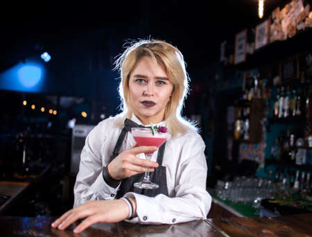 Girl barman creates a cocktail in the alehouseの写真素材