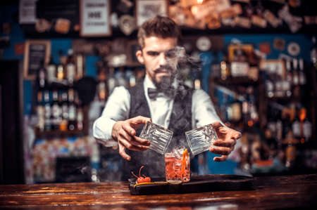 Barman mixes a cocktail in the beerhallの写真素材