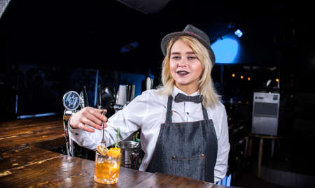 Girl barman makes a cocktail at the beerhouseの写真素材