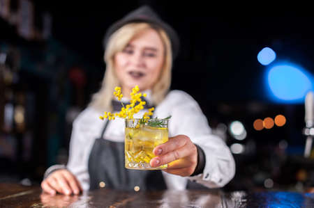 Girl bartender makes a cocktail at the barの写真素材