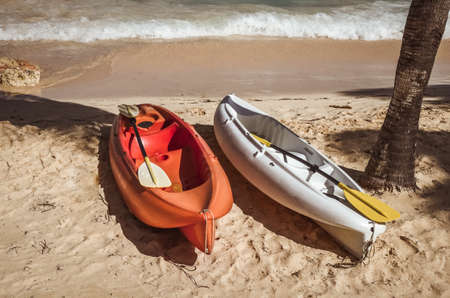 Two colorful kayaks on sand beachの写真素材
