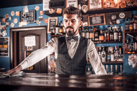 Charismatic tapster intensely finishes his creation at the nightclubの写真素材