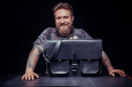 Handicraftsman producing leather goods in the shopの写真素材