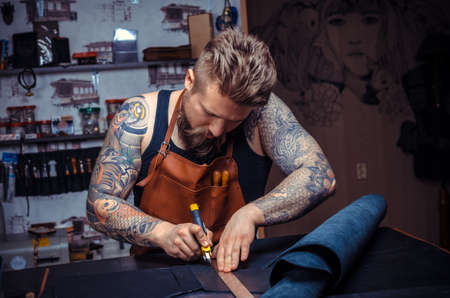 Man working with leather produces leather goodsの写真素材