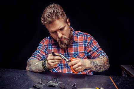 Leather Worker produces leather workpiece at the studioの写真素材