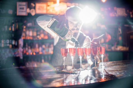 Bartender creates a cocktail at the saloonの写真素材