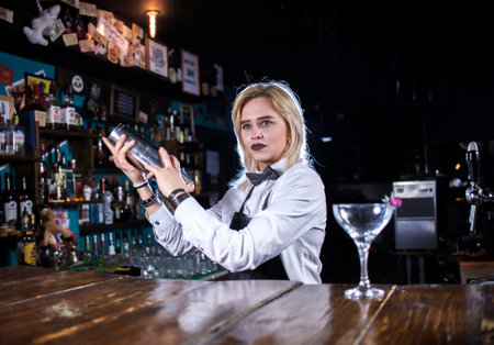 Experienced girl mixologist surprises with its skill bar visitors in the nightclubの写真素材
