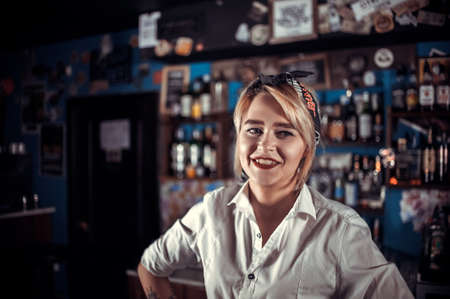 Confident girl bartender formulates a cocktail at the nightclubの写真素材