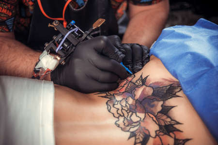 Tattooer at work in salonの写真素材
